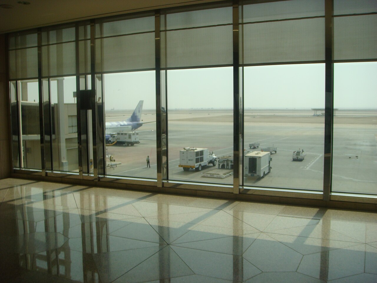 Aircraft at a gate seen from inside King Fahd International Airport Dammam