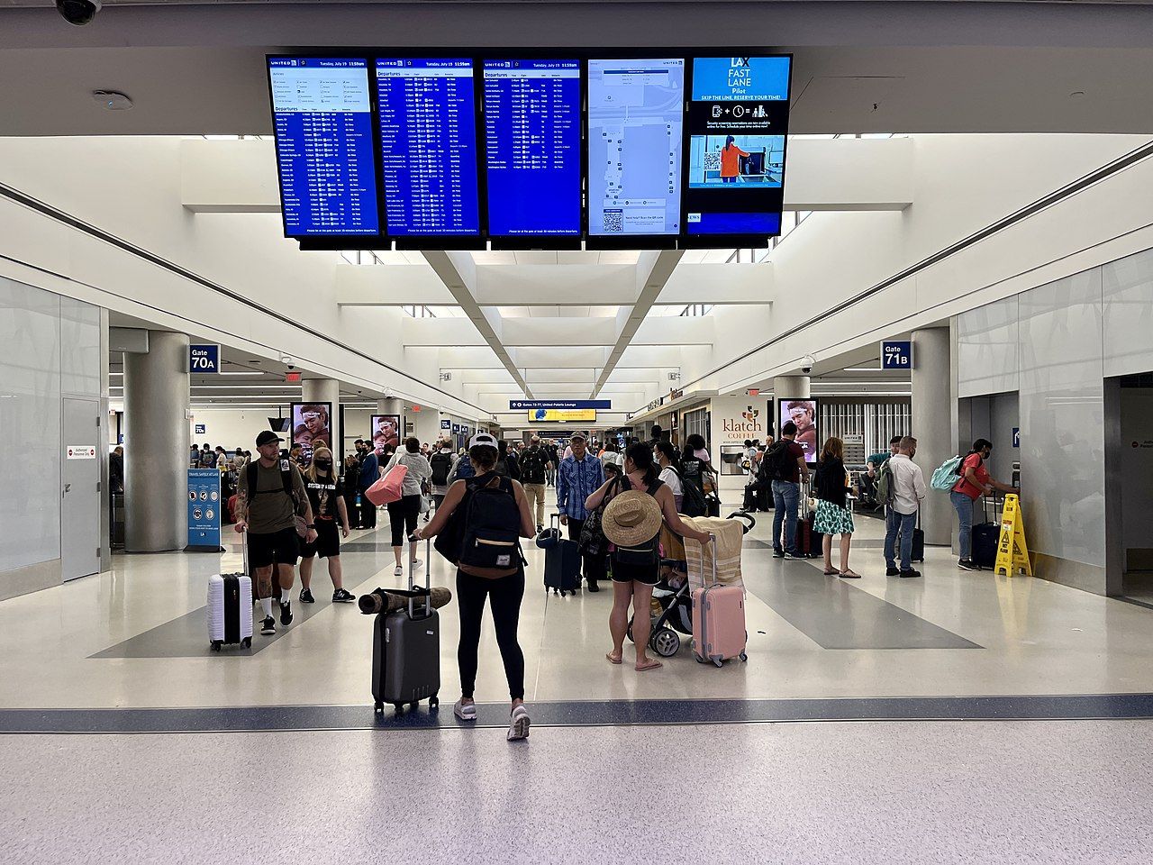 Terminal corridor with departure boards at Los Angeles International Airport